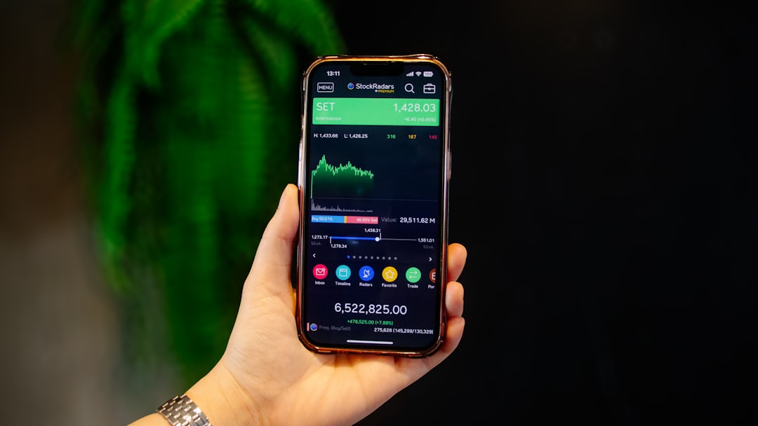 services-02 Hand Holding Smartphone with Stock Market Analysis Chart Dashboard Portfolio on Screen